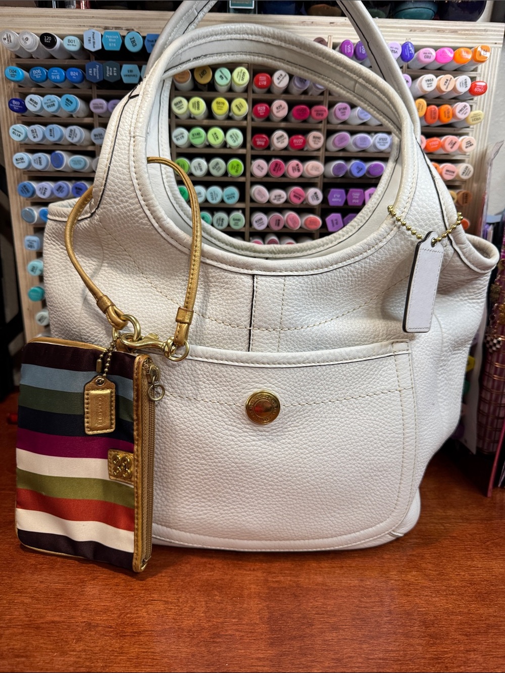 Coach Legacy Ergo in off white Pebbled Leather and Legacy Striped Wristlet